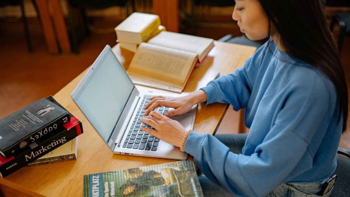 a student typing in laptop