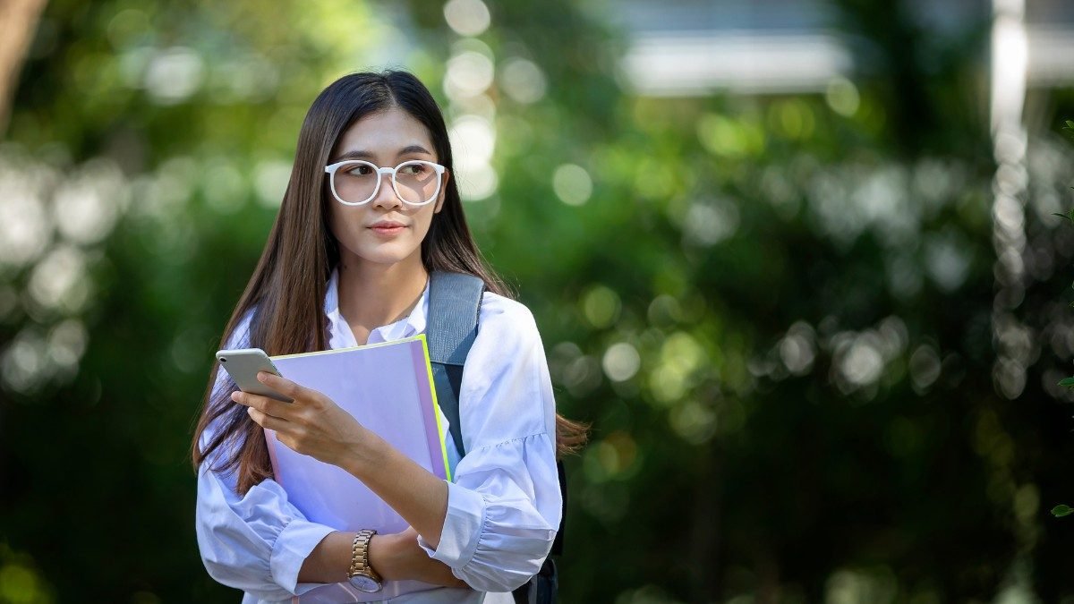 international student holding university student ID card